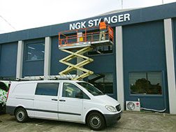 A scissor lift and van at the NGK building