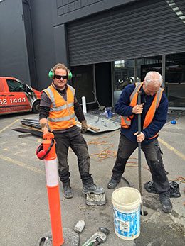Our director and a worker digging a footing